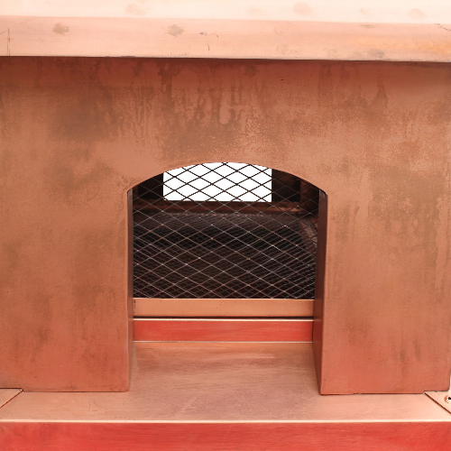 custom copper chimney cap pyramid shape in nature copper color with protective mesh and overhang at chimneycapmaster